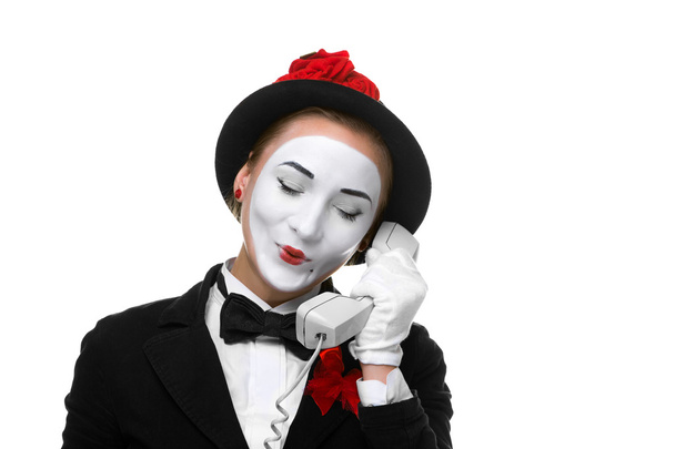Woman in the image mime holding a handset. - Photo, image