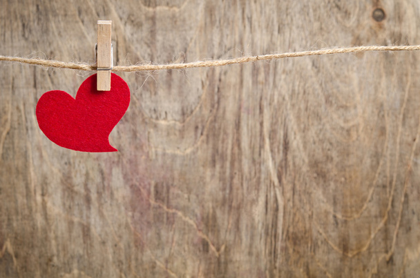 Red fabric heart hanging on the clothesline - Φωτογραφία, εικόνα