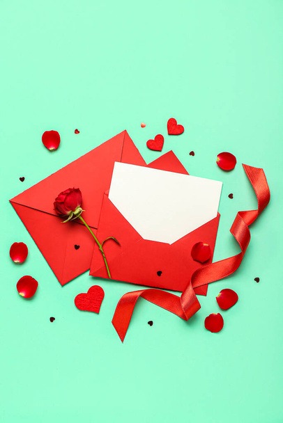 Blank letter with rose and hearts on green background. Valentine's Day celebration - Photo, Image