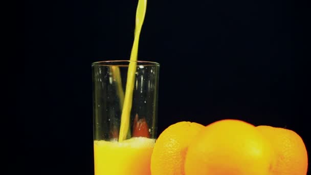 Orange juice is poured in a glass - Footage, Video