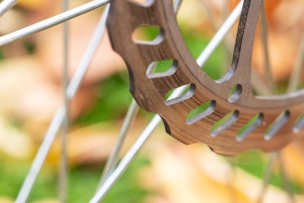 Ποδήλατα δισκόφρενα κοντά επάνω, γκρι δίσκος μετάλλων που συνδέεται με τροχό ποδηλάτου, αποτελεσματικά δημοφιλή φρένα ποδήλατο βουνού - Φωτογραφία, εικόνα
