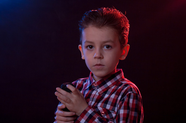 boy in party lights with microphone - Фото, зображення