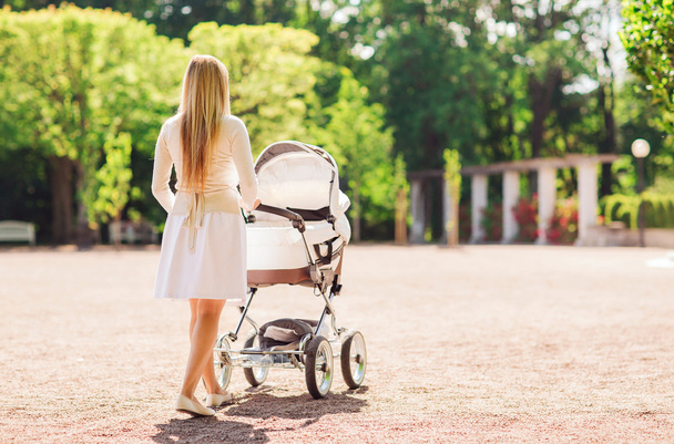 happy mother with stroller in park - 写真・画像