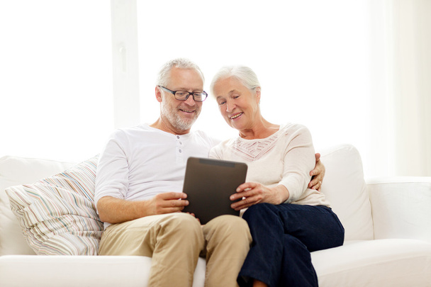 happy senior couple with tablet pc at home - Fotografie, Obrázek