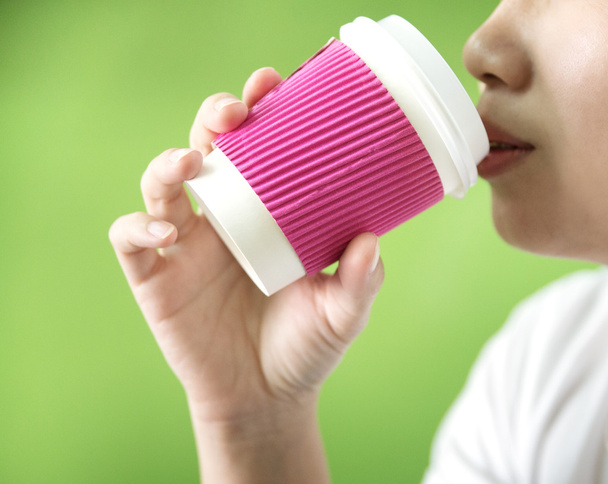Young woman drinking coffee from disposable cup  - Photo, Image