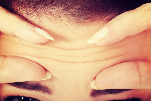 Woman checking her wrinkles on forehead. - Φωτογραφία, εικόνα