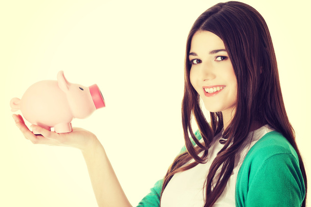 Young woman holding piggy-bank. - Photo, image