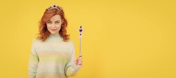 smiling redhead woman in queen crown with magic wand, wish. Woman isolated face portrait, banner with copy space - Foto, afbeelding