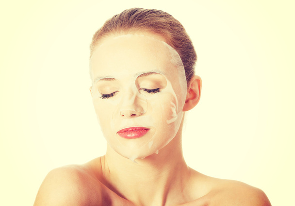 Beautiful woman with collagen mask on face. - Foto, afbeelding