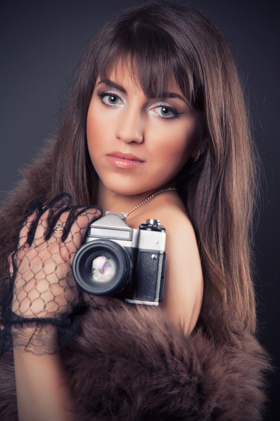 Woman holding vintage camera - 写真・画像