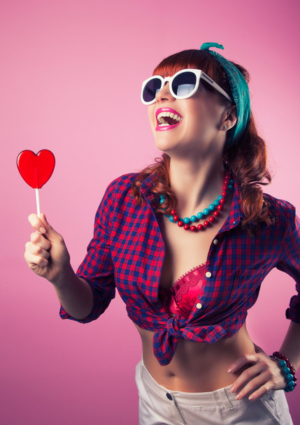 Girl  with red heart-shaped lollipop - Photo, Image