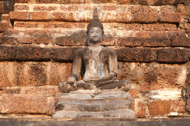 Ancient sitting Buddha in Wat Mahathat temple at Sukhothai Historical Park. - Photo, image