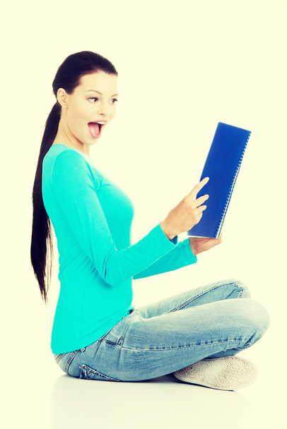 Beautiful young woman student with workbook. - Foto, immagini