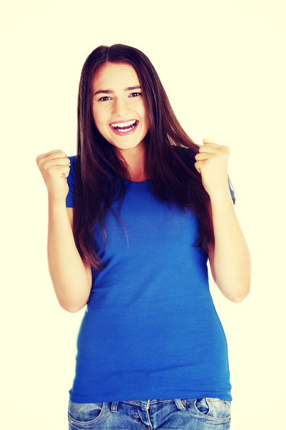 Happy casual woman with closed fists. - Foto, imagen