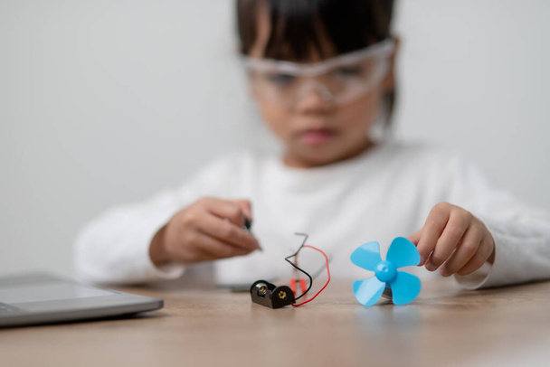 Asia students learn at home in coding robot cars and electronic board cables in STEM, STEAM, mathematics engineering science technology computer code in robotics for kids concept. - Photo, Image