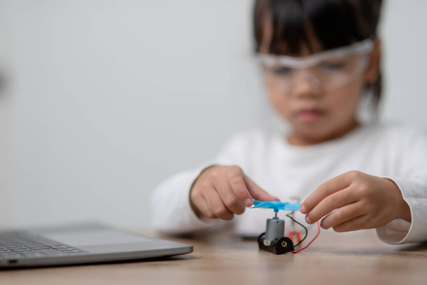 Asia students learn at home in coding robot cars and electronic board cables in STEM, STEAM, mathematics engineering science technology computer code in robotics for kids concept. - Photo, Image