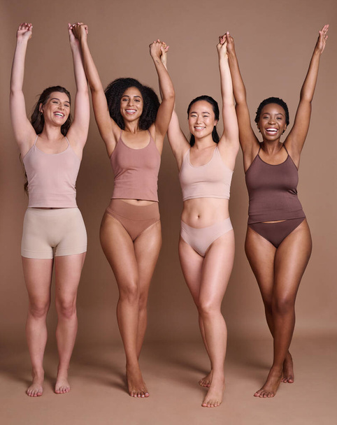 Diversity, woman and celebrate body positive in underwear for beauty motivation, happiness and confidence in studio. Interracial group of people, support and model smile celebration for solidarity. - Foto, Bild