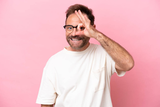 Middle age caucasian man isolated on pink background With glasses with happy expression - Photo, Image