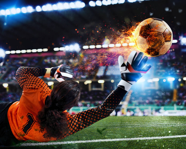 Futebol fechar cena no estádio de um goleiro que pega uma bola de fogo - Foto, Imagem