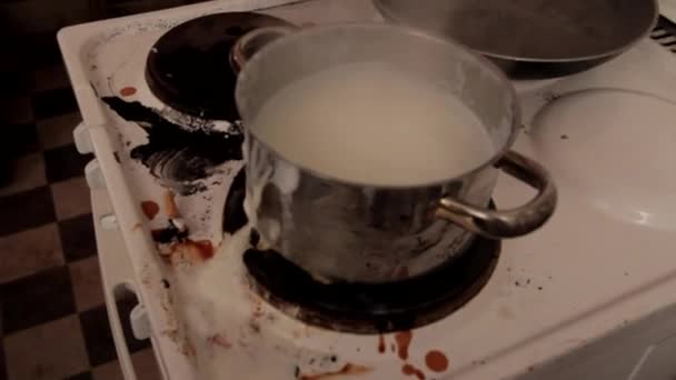 milk cooking and spilling at dirty oven. High quality FullHD footage - Footage, Video