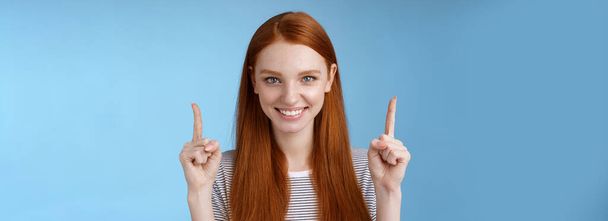 Lifestyle. Determined good-looking redhead female student enter college final decision pointing up index fingers raised confidently smiling white teeth look camera assertive giving recommendation what - Photo, Image