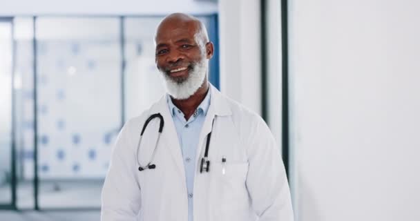 Healthcare, doctor and face of black man in hospital, health facility and clinic for trust, support and help. Insurance, medical care and portrait of senior medical worker with smile for consulting. - Footage, Video