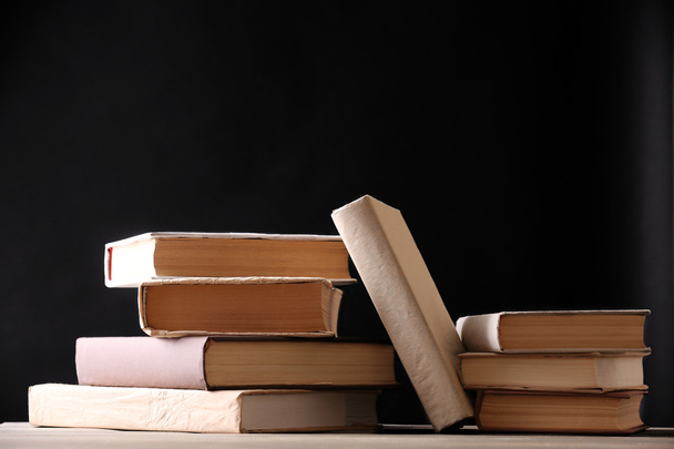 Stack of books on wooden planks background - Foto, Imagen