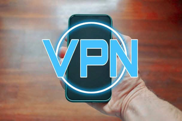 hand holding a smart phone with vpn icon  - Photo, Image
