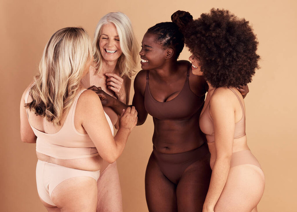 Diversity, women and skincare for body positivity, wellness and talk on brown studio background. Cosmetics, females or multiracial ladies conversation, natural beauty or confident with smile or laugh. - Photo, Image
