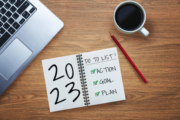 2023 Happy New Year Resolution Goal List and Plans Setting - Business office desk with notebook written about plan listing of new year goals and resolutions setting. Change and determination concept. - Photo, Image