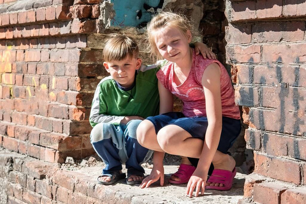 A testvérpár a katonai konfliktusok és a természeti katasztrófák miatt egyedül maradt. Gyermekek egy tönkrement és elhagyott házban. Szakaszos fénykép. - Fotó, kép