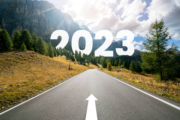 2023 New Year road trip travel and future vision concept . Nature landscape with highway road leading forward to happy new year celebration in the beginning of 2023 for fresh and successful start . - Photo, Image