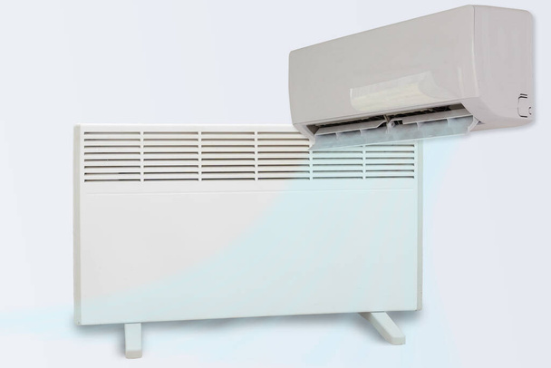 Modern elektromos fűtőberendezés és légkondicionáló fehér alapon. - Fotó, kép