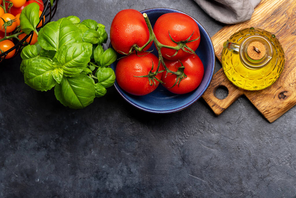 Ingredients for cooking. Italian cuisine. Tomatoes, basil and olive oil. Flat lay with copy space - Photo, Image