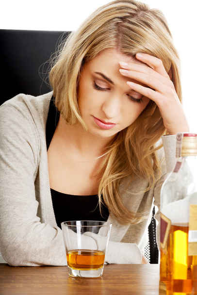 Yound woman in depression, drinking alcohol - Фото, изображение