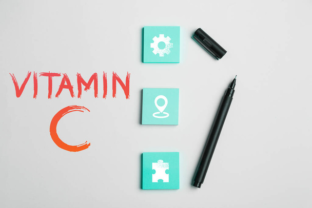 Κείμενο γραφής Βιταμίνη C, Επιχειρηματική επισκόπηση που προωθεί την επούλωση και βοηθά το σώμα να απορροφήσει σίδηρο Ασκορβικό οξύ - Φωτογραφία, εικόνα