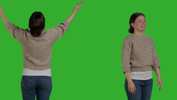 Close up of positive woman sending air kisses on camera, acting friendly and confident in studio. Optimistic lovely person expressing love and romantic feeling over greenscreen background. - Footage, Video