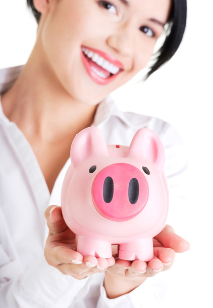 Happy businesswoman holding piggy bank - Zdjęcie, obraz