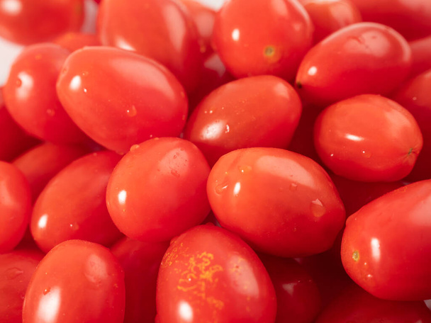 Red cherry tomatoes. Red tomatoes on a white background. Close-up. - Photo, Image