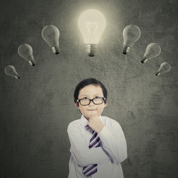 Schoolboy under bright lightbulb - Фото, изображение