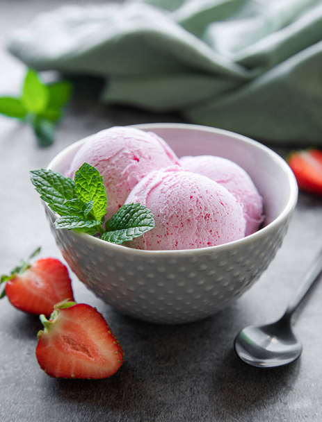 Homemade strawberry  ice cream with fresh strawberries. Sweet berry summer dessert. Concrete background - Photo, Image