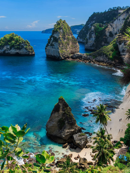 Diamond beach with blue ocean and scenic coastline with rocks and mountain in Nusa Penida - Photo, Image