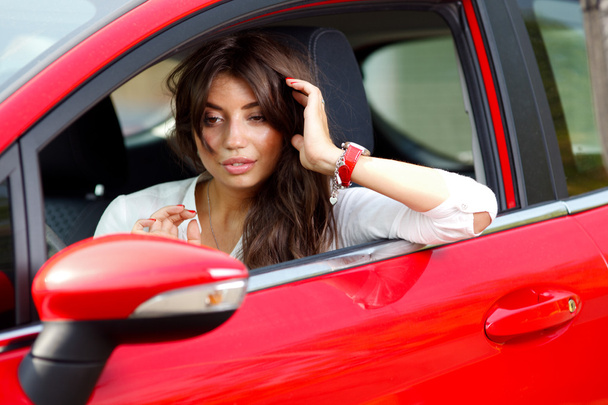 Young pretty woman in the red car - Fotografie, Obrázek