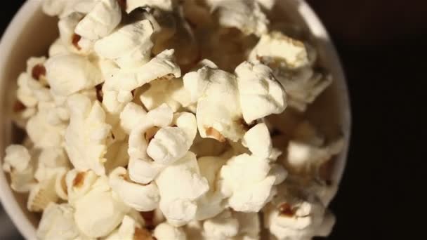 white glass with popcorn rotates close up. Top view - Footage, Video