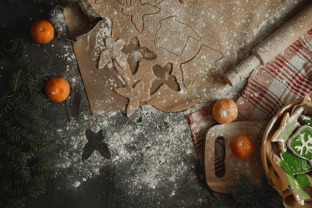 cut out figures and make christmas cookies, raw dough molds for christmas cookies, gingerbread man, raw dough with ginger, cinnamon flavor, concept of christmas and new year traditions, merry christmas, happy new year 2023 - 写真・画像
