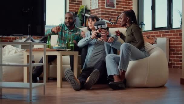 Diverse group of friends celebrating video games win after playing with vr headset and television console. Winning online gaming challenge with virtual reality glasses, having fun. Tripod shot. - Footage, Video