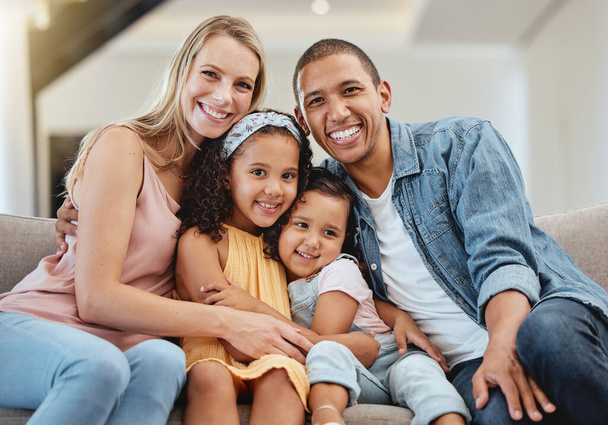 Love, diversity and portrait of happy family hug in rent house living room, bonding and enjoy quality time together. Happiness, child support care and children with mother, father or parents on sofa. - Foto, Imagen
