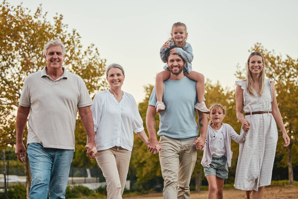 Nature, portrait and big family on a walk in the park for fresh air, exercise and adventure. Grandparents, parents and children walking together and holding hands in an outdoor garden in Australia - Foto, Imagem