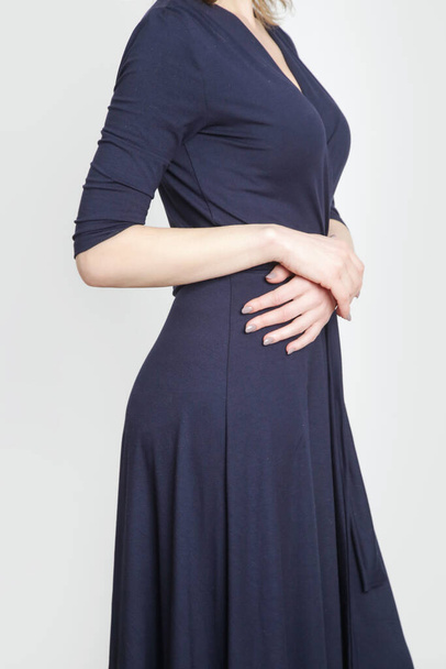 Serie of studio photos of young female model in dark blue maxi viscose wrap dress. - Photo, Image