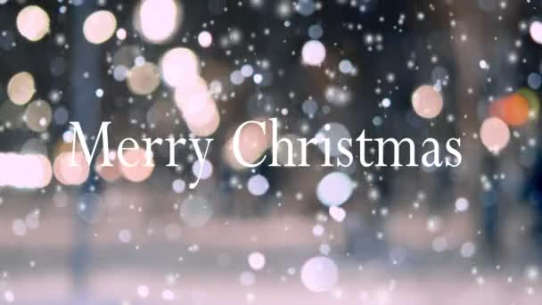 Words Merry Christmas on blurred background of night city with glowing lanterns and falling snow. Celebration Holidays Christmas New Year. Winter snow snowfall snowflakes snow falls. Blurry backdrop - Footage, Video